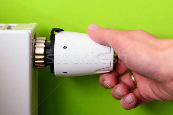 Radiator thermostat and hand - GREEN POWER energy SAVING concept Stock photo © bubutu