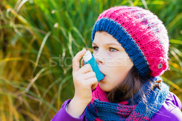 Stock photo: Girl Using Inhaler on a autumn day