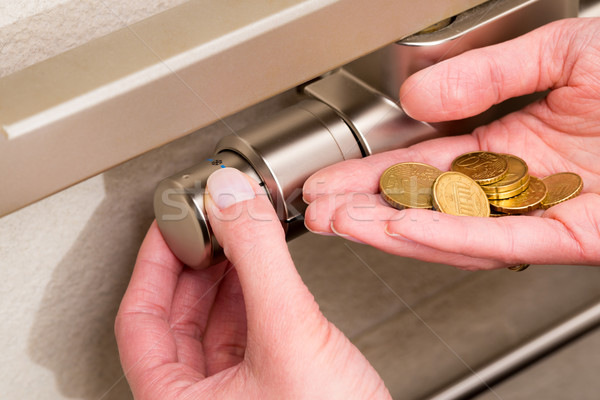 Radiator thermostat, coins and hand Stock photo © bubutu