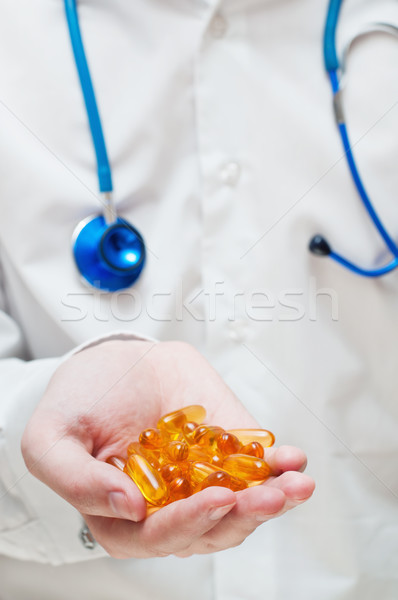 Doctor's hand with gel capsules Stock photo © burtsevserge