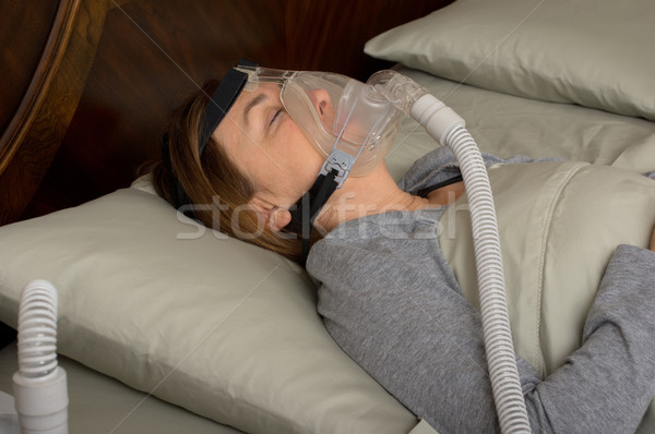 Alszik nő visel gép maszk hálószoba Stock fotó © BVDC
