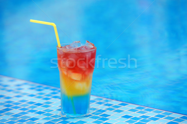 Cocktail at the edge of the swimming pool Stock photo © byrdyak