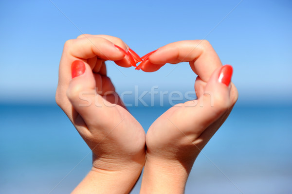 Female hand making a heart shape against Stock photo © byrdyak