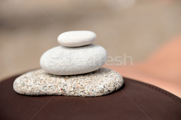 Bitter round stones on the body girl Stock photo © byrdyak