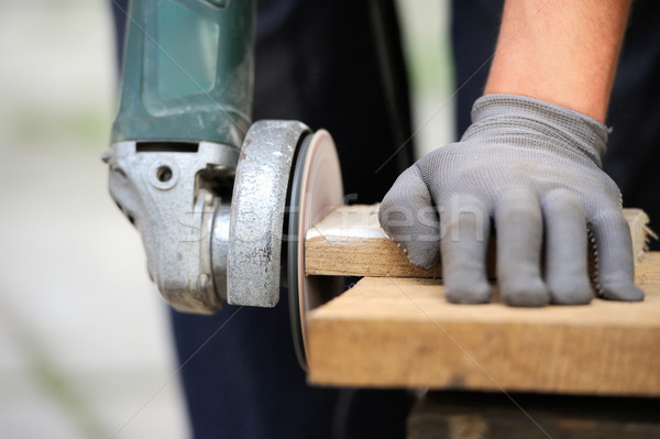 Worker polishing a wood table Stock photo © byrdyak