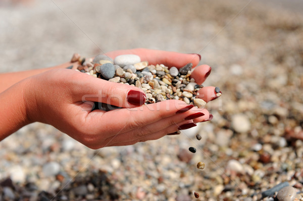 Hands dropping small stones Stock photo © byrdyak