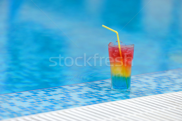 Cocktail at the edge of the swimming pool Stock photo © byrdyak