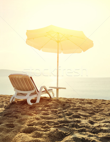 Beach loungers at sunrise Stock photo © byrdyak