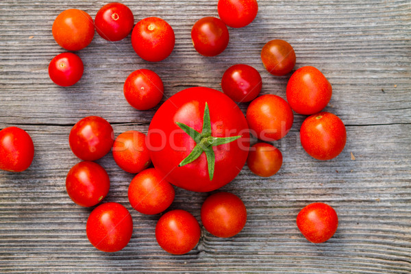 fresh red delicious tomatoes on an old wooden tabletop Stock photo © c12