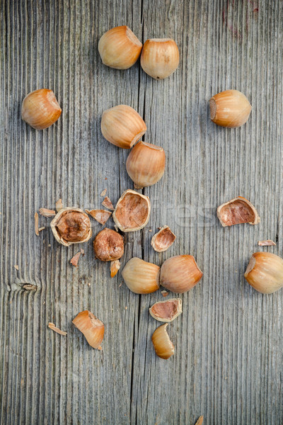 cracked nuts on old wooden background Stock photo © c12