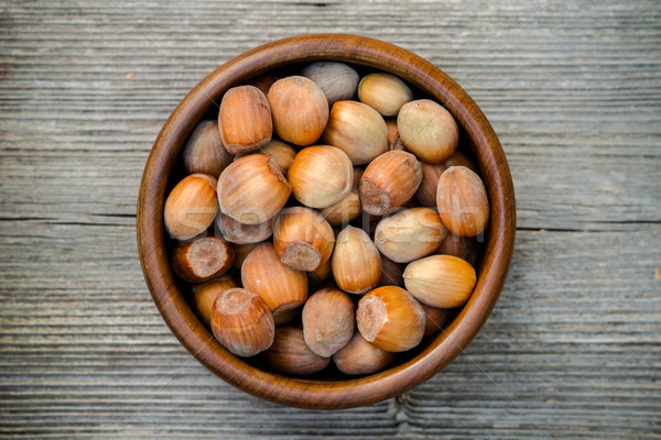 nuts in a bowl - rustic wooden table Stock photo © c12