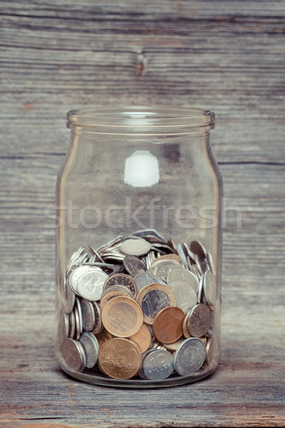 money jar with coins on wood table Stock photo © c12