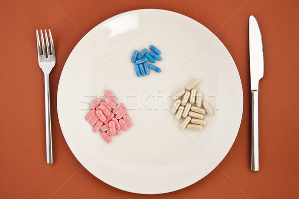 Pillole cena piatto pasto diverso coltello Foto d'archivio © caimacanul