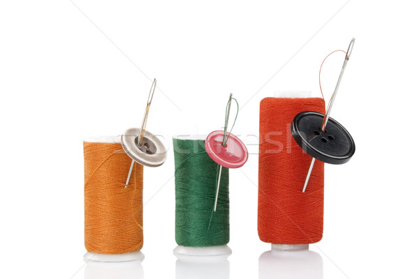 Stock photo: colored spool, needles and buttons
