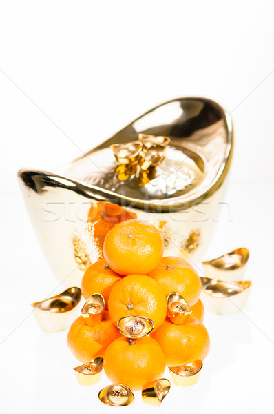 Golden ingots represent wealth and plump mandarin oranges signify good luck for Chinese New Year fes Stock photo © calvste