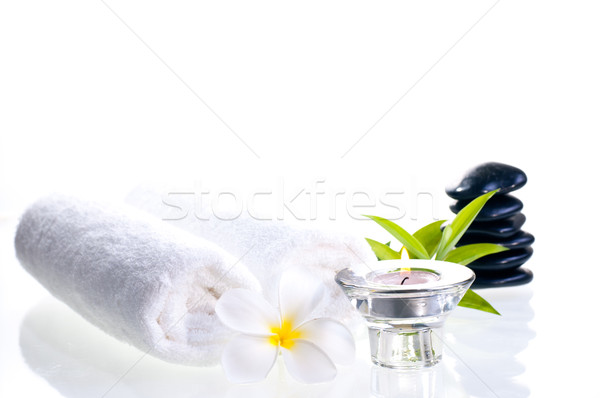 Spa concept with black zen stones and white frangipani  Stock photo © calvste