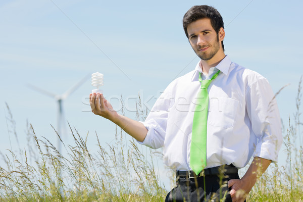 Green energy businessman in field hold bulb Stock photo © CandyboxPhoto