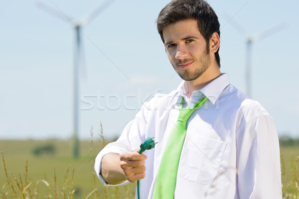 Green energy businessman in field hold plug Stock photo © CandyboxPhoto