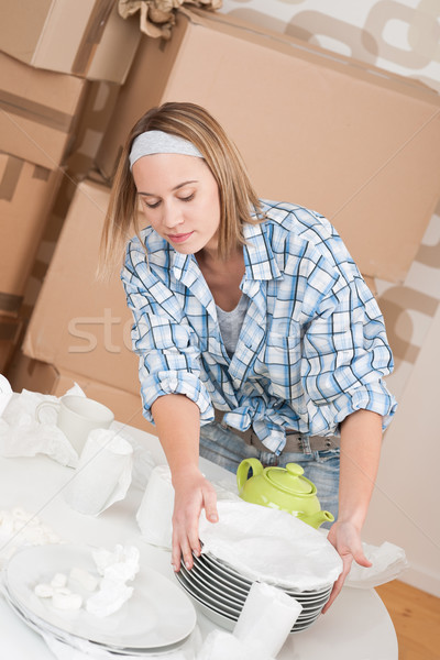Moving house: Woman unpacking box Stock photo © CandyboxPhoto