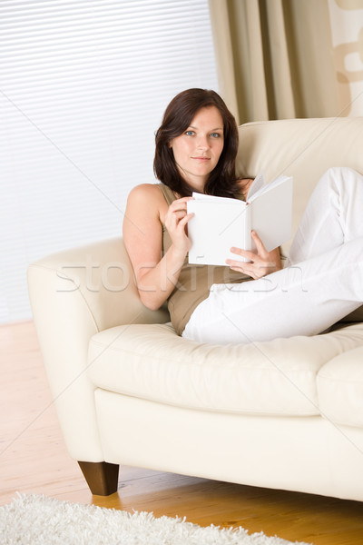 Young woman read book relaxing on sofa Stock photo © CandyboxPhoto