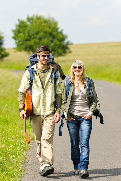 Hiking young couple backpack tramping asphalt road Stock photo © CandyboxPhoto