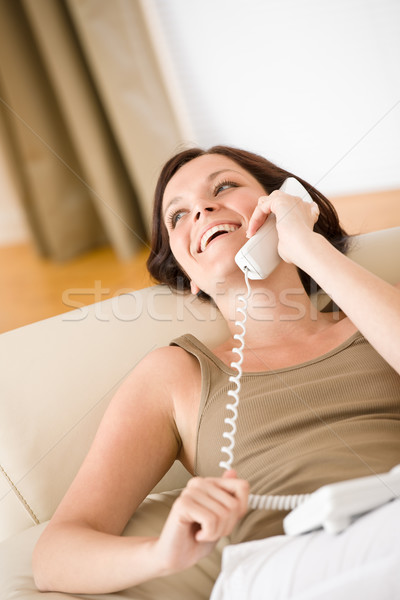 Telefon otthon mosolygó nő kanapé hív fekszik Stock fotó © CandyboxPhoto