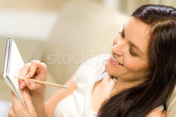 Happy woman taking notes into notepad Stock photo © CandyboxPhoto