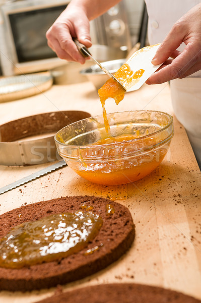 Chef pouring apricot jam to glass bowl Stock photo © CandyboxPhoto