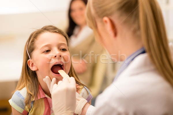Pediatrician examine girl throat tongue Stock photo © CandyboxPhoto