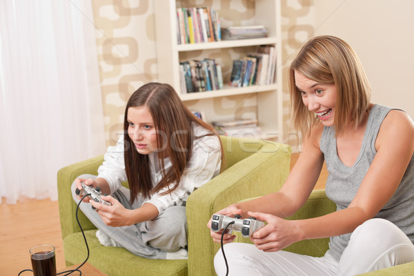 Students - Two female teenager playing video TV game Stock photo © CandyboxPhoto