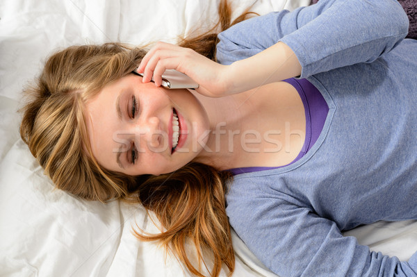 Girl lying in bed talking on phone Stock photo © CandyboxPhoto