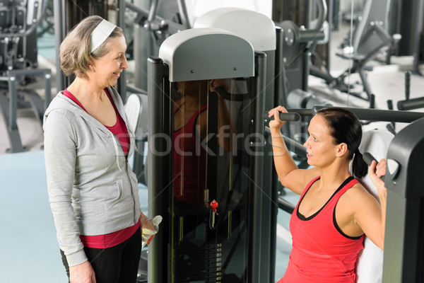 Personal trainer at fitness center showing exercise Stock photo © CandyboxPhoto