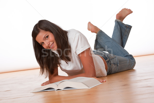 Happy teenager lying down with book Stock photo © CandyboxPhoto