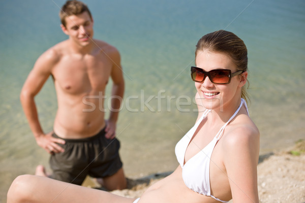 Couple on beach - woman in bikini sunbathing Stock photo © CandyboxPhoto