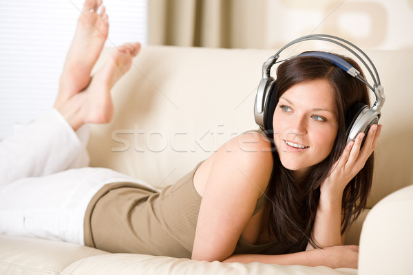 Stockfoto: Gelukkig · vrouw · hoofdtelefoon · sofa · salon