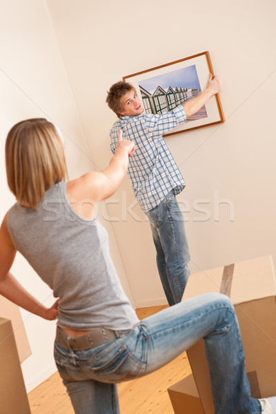 Moving house: Couple hanging picture on wall Stock photo © CandyboxPhoto