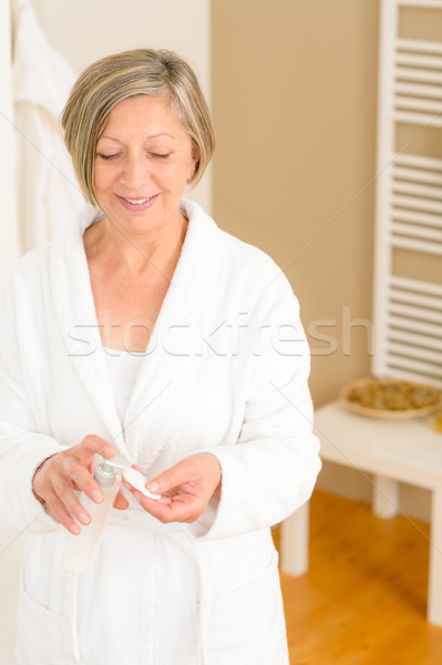Senior woman bathroom apply cream cotton pad Stock photo © CandyboxPhoto