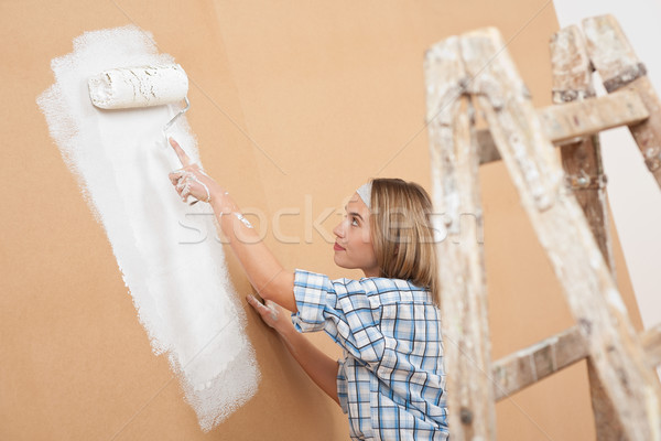 Stock photo: Home improvement: Woman painting wall 