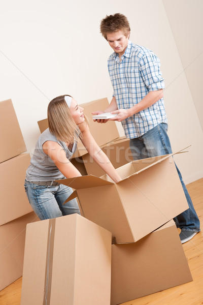 Moving house: Young couple with box in new home Stock photo © CandyboxPhoto