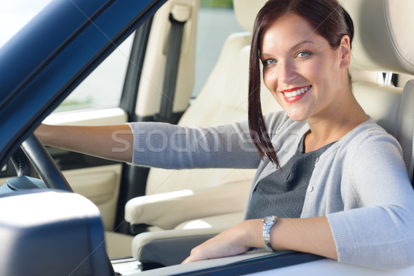 Stock photo: Attractive businesswoman drive luxury car smiling