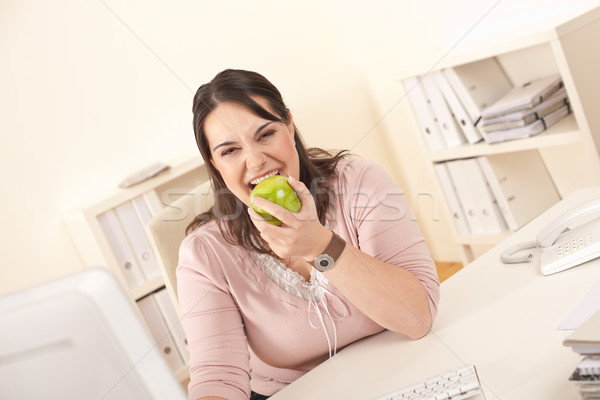 Young businesswoman biting apple at office Stock photo © CandyboxPhoto