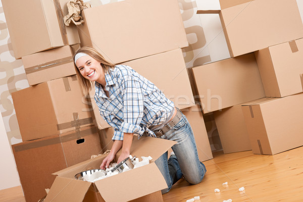 Moving house: Happy woman unpacking box  Stock photo © CandyboxPhoto