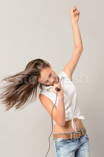 Dancing teenage girl singing with microphone Stock photo © CandyboxPhoto