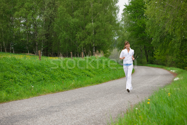 Jogging - sportive woman running on road in nature Stock photo © CandyboxPhoto