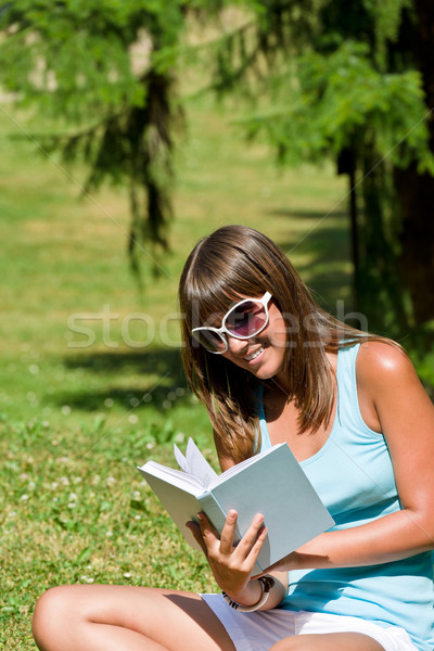 Stock photo: Happy young woman with book in park 