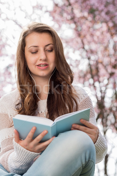 Student reading book near blossoming tree spring Stock photo © CandyboxPhoto