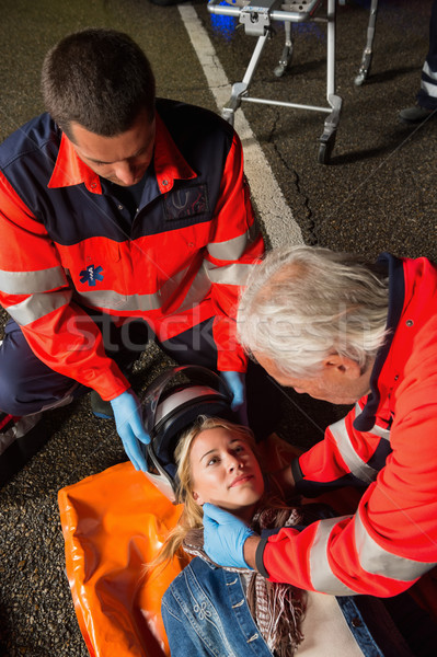 Paramedics removing helmet from motorcycle driver Stock photo © CandyboxPhoto
