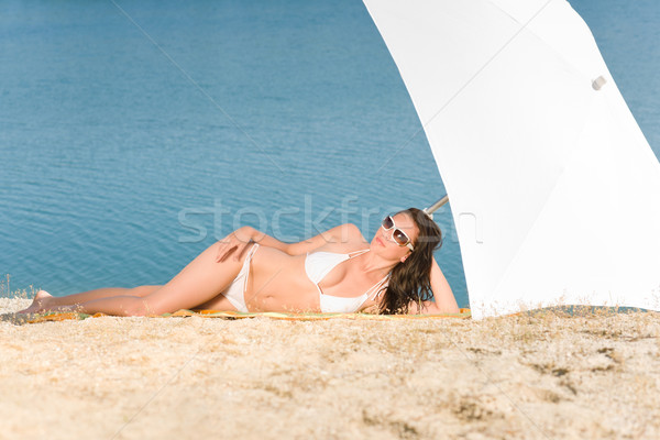 Genç seksi bikini modeli rahatlatıcı güneş gözlüğü plaj Stok fotoğraf © CandyboxPhoto