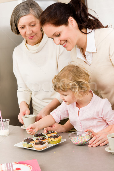 Daughter and mother decorating cupcakes sprinkles Stock photo © CandyboxPhoto