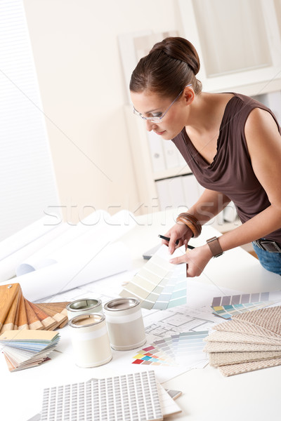 Stock photo: Young female designer working with color swatches